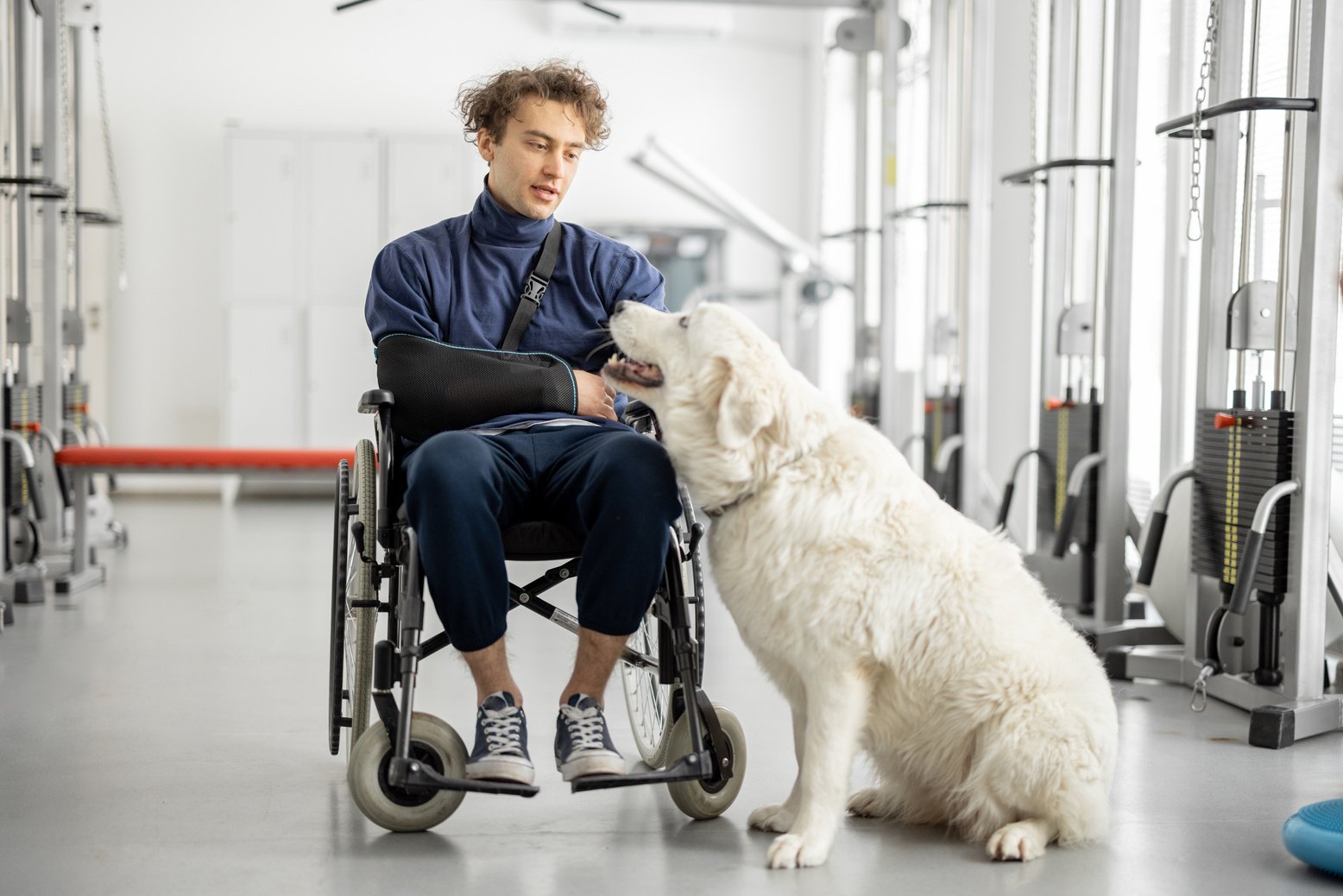 Man in a Wheelchair with His Dog at Rehabilitation Center